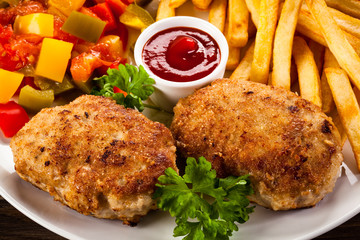 Fried chops, French fries and vegetable salad
