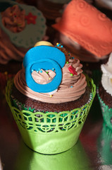 Cupcake with colorful figures made of fondant