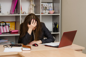 Girl in the office clutching her head