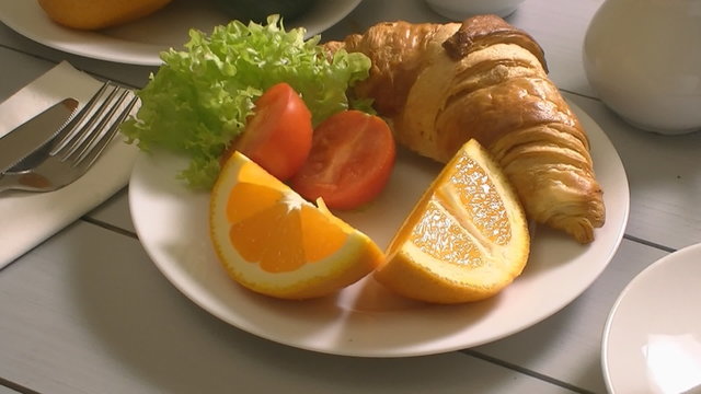Breakfast with croissant, tomato end tea