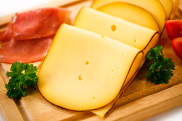 Cheese on cutting board on white background