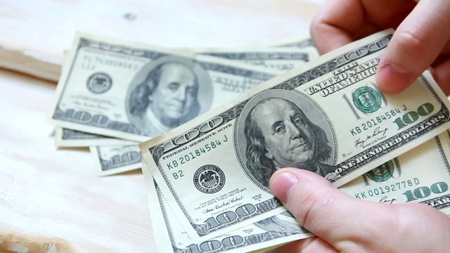 man's hands counting money.Dollars.Paper Money.