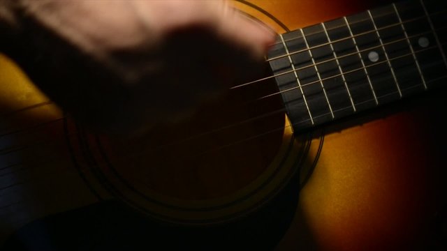 Acoustic Guitar Strumming Close Up