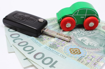 Money, green toy car and key vehicle. White background