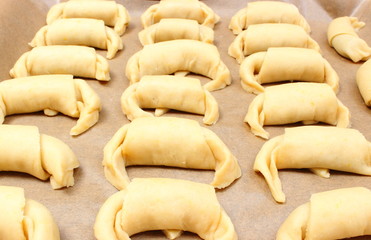 Preparing fresh croissants with jam