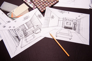 On the table are a drawing of pencil-drawn design room design. In the frame, a sheet of paper on a...