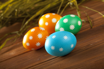 Obraz na płótnie Canvas Easter eggs on wooden boards