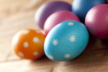 Fototapeta na wymiar Colored Easter eggs on wooden background
