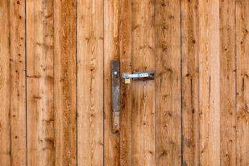 Closeup shot of metal door handle on big wooden door