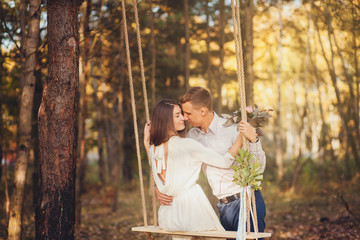 Romantic couple in a summer park. Man hugging a girl