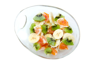 Bowl with sliced fruit on a white background top view