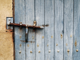 rusty latch on an old blue door