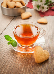 Glass cup of tea on a wooden table.