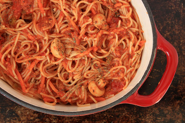 Spaghetti with tomato sauce and vegetables in red Dutch oven - 78966900