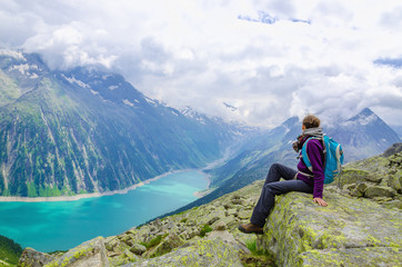 Fototapeta na wymiar Beautiful alpine landscape with young woman and azure lake