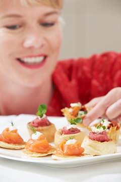 Woman Eating Appetizers On Plate