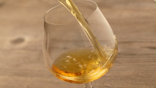 Pouring brandy or whiskey into glass