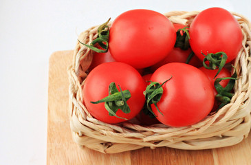 fresh cherry tomatoes in straw basket