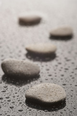 Fototapeta na wymiar Spa massage stones with water drops, close up