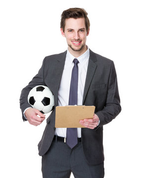 Football manager hold with a soccer and clipboard
