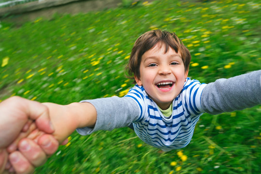 Cute Boy Laughing Being Spun Around