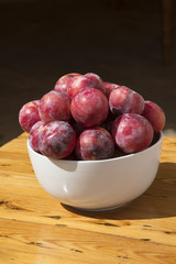 African sweet plums in a white bowl