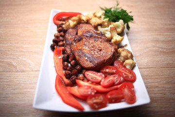 grilled meat cooked with nuts and vegetables serving