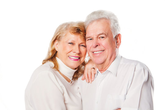 Close up of smiling senior couple in love. Isolated over white