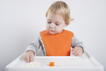 baby eating rice and carrot