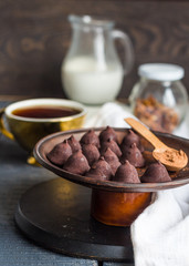 Candy chocolate truffles, cream jug and a cup of coffee