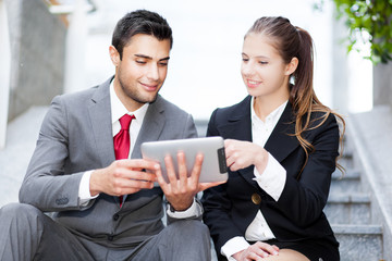 Business people using a digital tablet