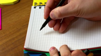 The man draws on paper - Powered by Adobe