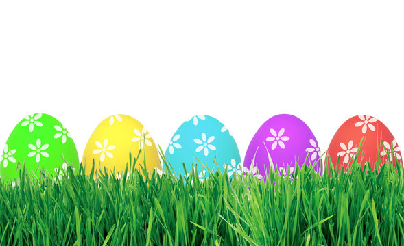 Easter eggs in green grass isolated on white