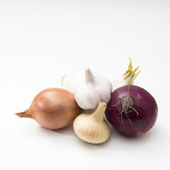 fresh vegetables garlic and onions isolated on the white