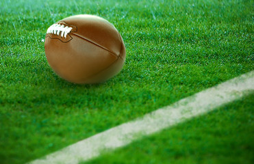American football on green grass