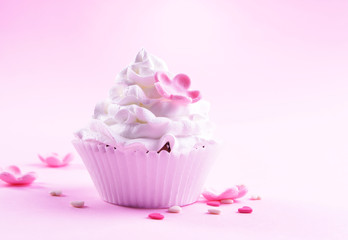 Delicious cupcake on pink background