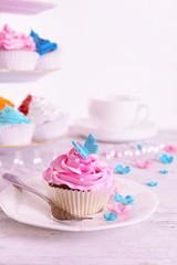 Delicious cupcakes on plate on table close-up