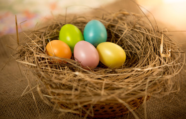 Fototapeta na wymiar Easter eggs lying on table at nest
