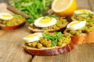 Sandwiches with green peas paste and boiled egg with herbs and