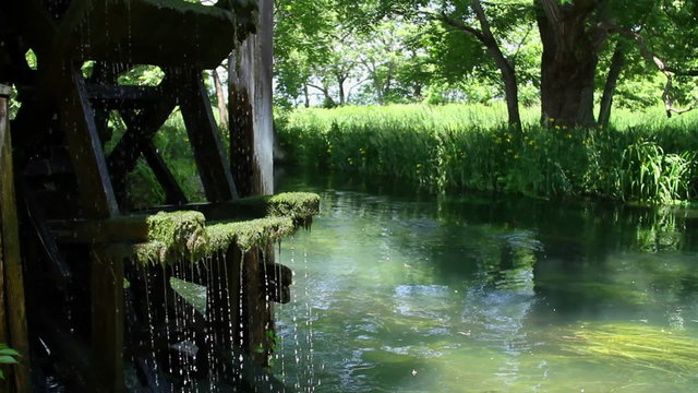 water wheel and clear stream