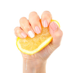 Female hand squeezing lemon isolated on white