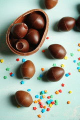 Chocolate Easter Eggs on color wooden background
