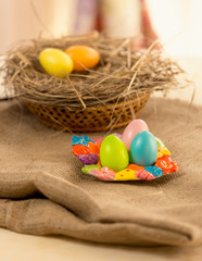 colorful Easter eggs lying on table covered with burlap