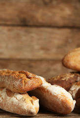 Different fresh bread on old wooden table