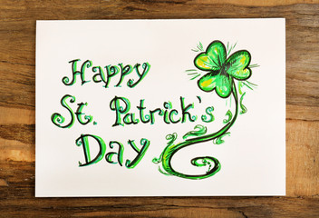 Greeting card for Saint Patrick's Day on wooden table