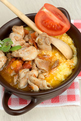 polenta - corn porridge with stewed chicken in oil