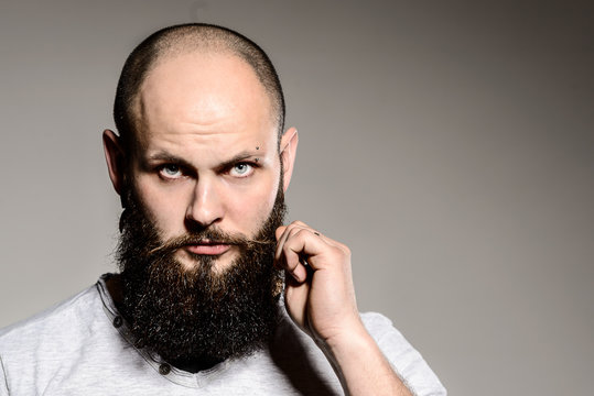 Closeup Of Bearded Man Touching His Beard