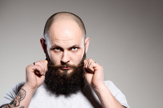 Bearded Man Touching His Beard