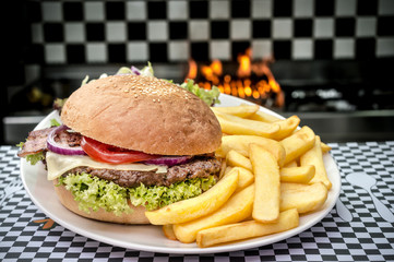 American hamburger with French fries in flames