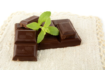 Group of blocks of chocolate with sage on white material
